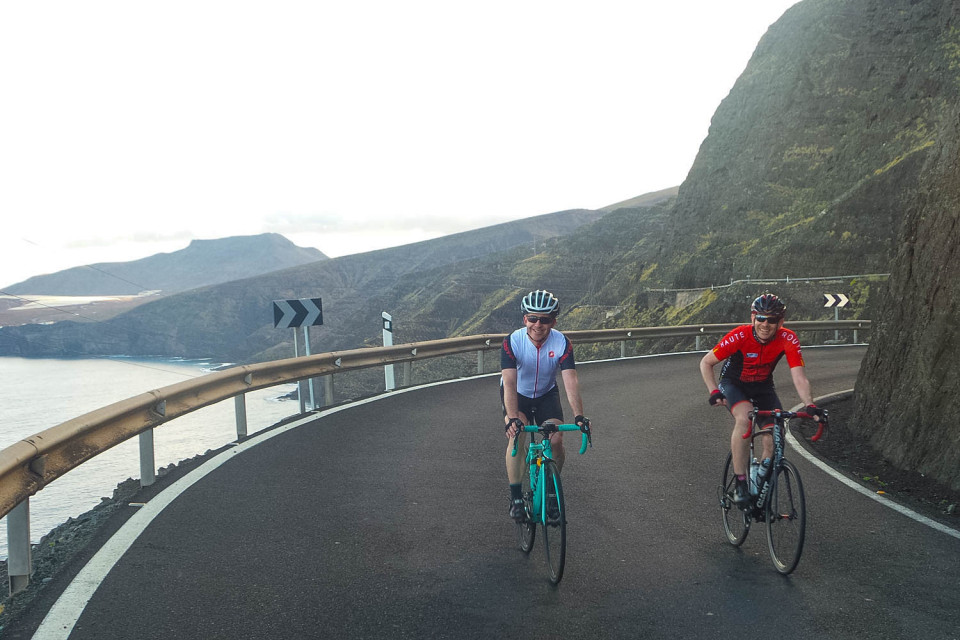 Pair of cyclists on west coast road on full support guided road cycling tour Gran Canaria with Marmot Tours
