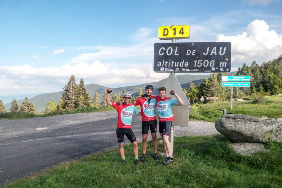 Three cyclists celebrating on the Col de Jau on the Marmot Tours Raid Pyrenean