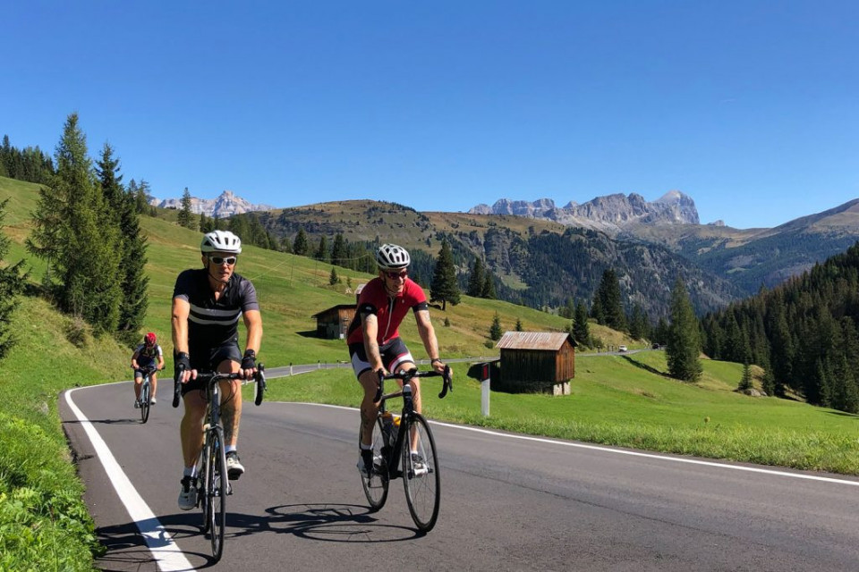 Cyclists enjoying a climb in Dolomites Italy on Marmot Tours guided road cycling tour