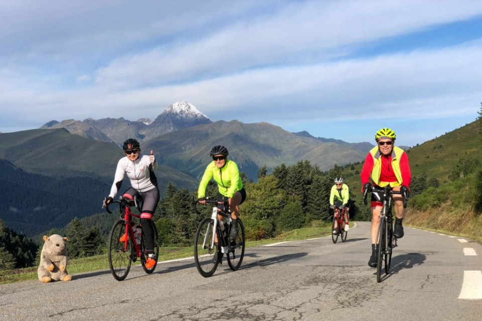 Group of cyclists approaching summit of Col d'Aspin on Raid Pyrenean cycling challenge with Marmot Tours