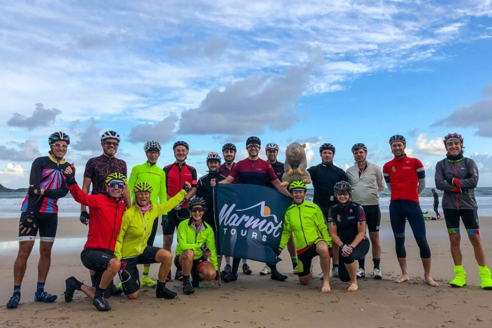 Group of cyclists on beach at Hendaye on day 1 of Raid Pyrenees with Marmot Tours guided road cycling holidays